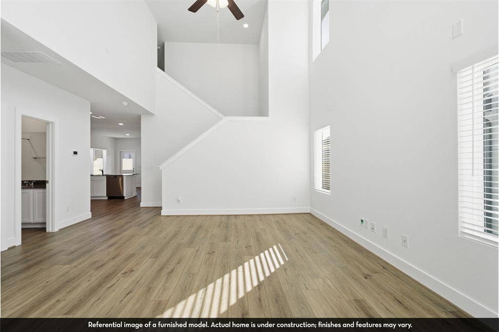 821 Whitmore Drive, Princeton, TX 75071 Double-height ceiling, wood-finish flooring, recessed lighting, and wall-mounted ceiling fan