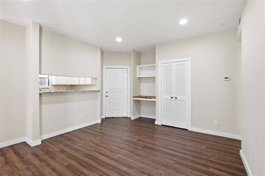 4414 Point Boulevard, #115, Garland, TX 75043 Wood-finish flooring throughout, recessed lighting, and built-in desk with shelving