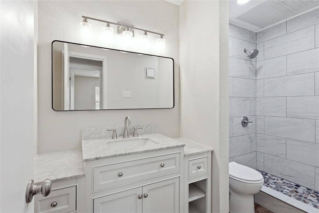 4414 Point Boulevard, #115, Garland, TX 75043 White vanity with undermount sink, marble-finish countertop, and brushed nickel fixtures