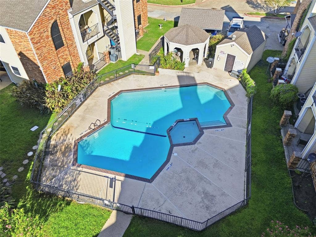 4414 Point Boulevard, #115, Garland, TX 75043 Fenced swimming pool with integrated spa and surrounding concrete decking