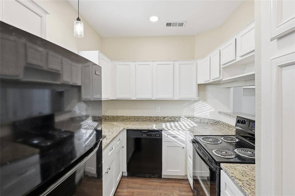 4414 Point Boulevard, #115, Garland, TX 75043 Kitchen featuring white cabinetry, granite-style countertops, wood-finish flooring, a black electric range, and a black dishwasher