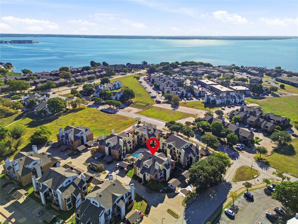 4414 Point Boulevard, #115, Garland, TX 75043 Waterfront community featuring multi-story residential buildings and an outdoor swimming pool