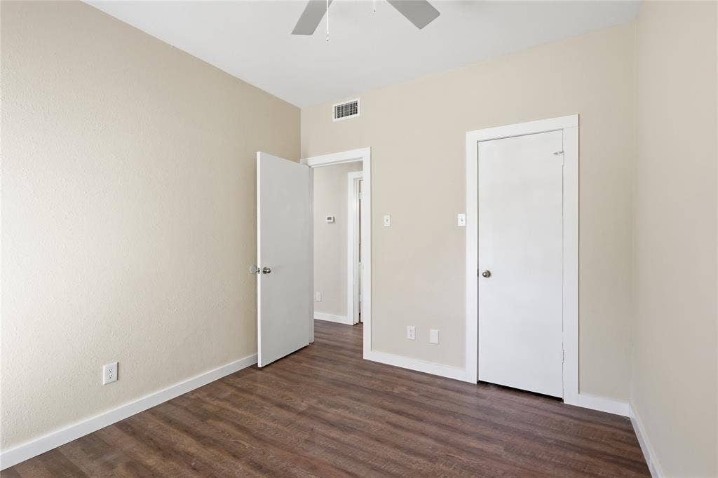4414 Point Boulevard, #115, Garland, TX 75043 Wood-finish flooring, neutral wall tones, white trim details, ceiling fan, and white interior doors