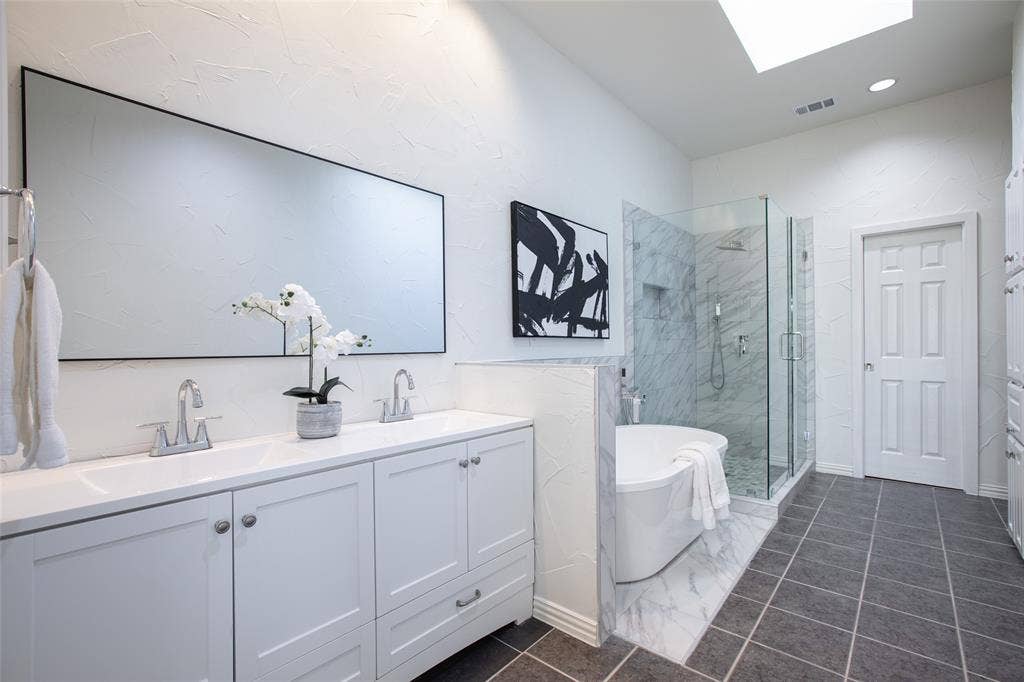 Spacious and modern with high-end finishes, double vanity, walk-in glass shower, and a relaxing free standing soaking tub.