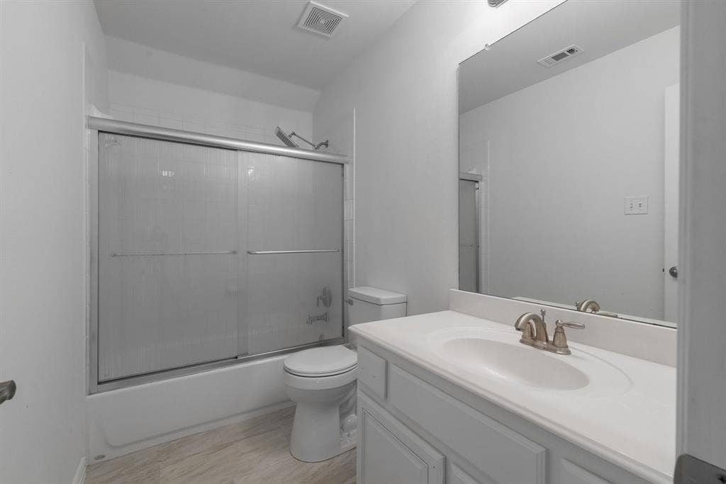 White bathroom vanity with an integrated sink and brushed nickel faucet