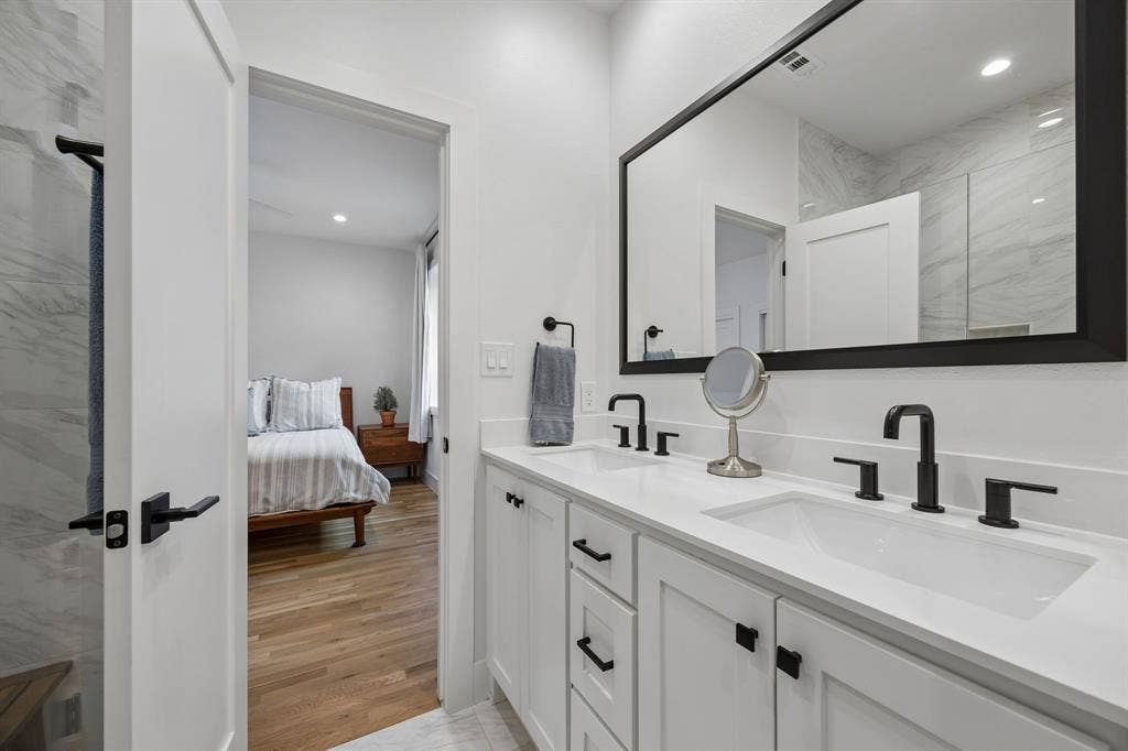 7207 Gaston Avenue, #903, Dallas, TX 75214 Bathroom with recessed lighting, double vanity, a marble finish shower, ensuite bath, and light wood-style flooring