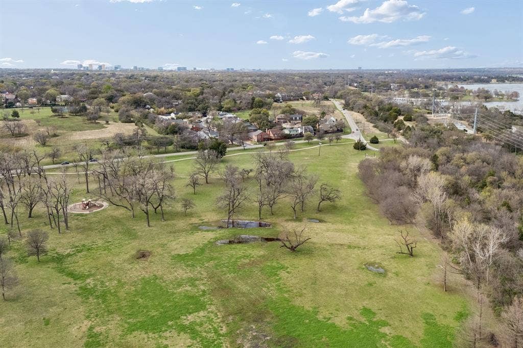 7207 Gaston Avenue, #903, Dallas, TX 75214 Bird's eye view of White Rock Lake, showcasing the expansive green spaces of the surrounding parks and winding trails.