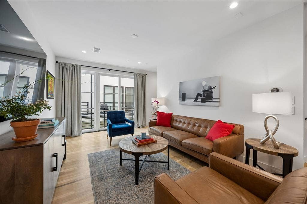 7207 Gaston Avenue, #903, Dallas, TX 75214 Bright and inviting living area featuring light oak wood flooring, recessed lighting, and an open floor plan filled with abundant natural light, creating an airy and welcoming atmosphere ideal for everyday living and entertaining.