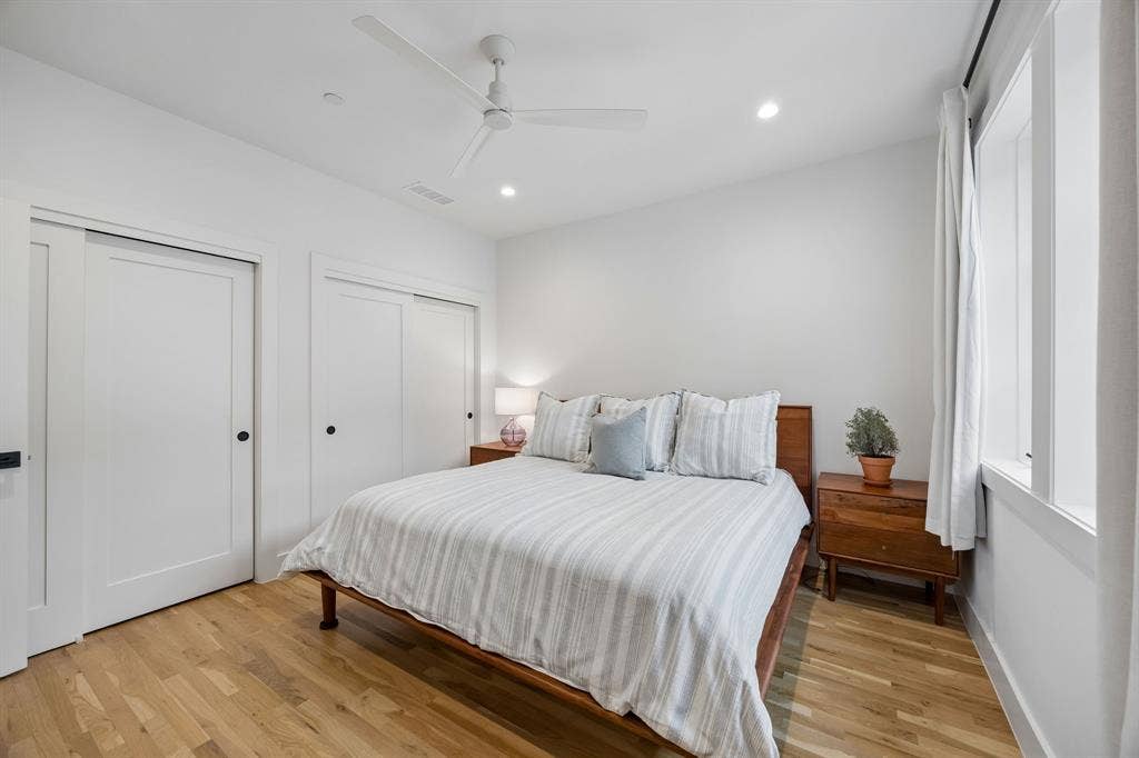 7207 Gaston Avenue, #903, Dallas, TX 75214 Bedroom with two closets, light oak wood flooring, recessed lighting, and a ceiling fan.