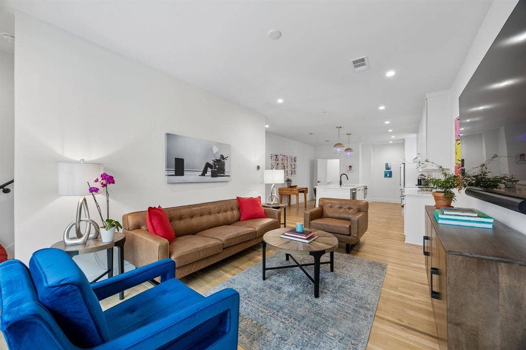7207 Gaston Avenue, #903, Dallas, TX 75214 Bright and inviting living area featuring light oak wood flooring, recessed lighting, and an open floor plan filled with abundant natural light, creating an airy and welcoming atmosphere ideal for everyday living and entertaining.