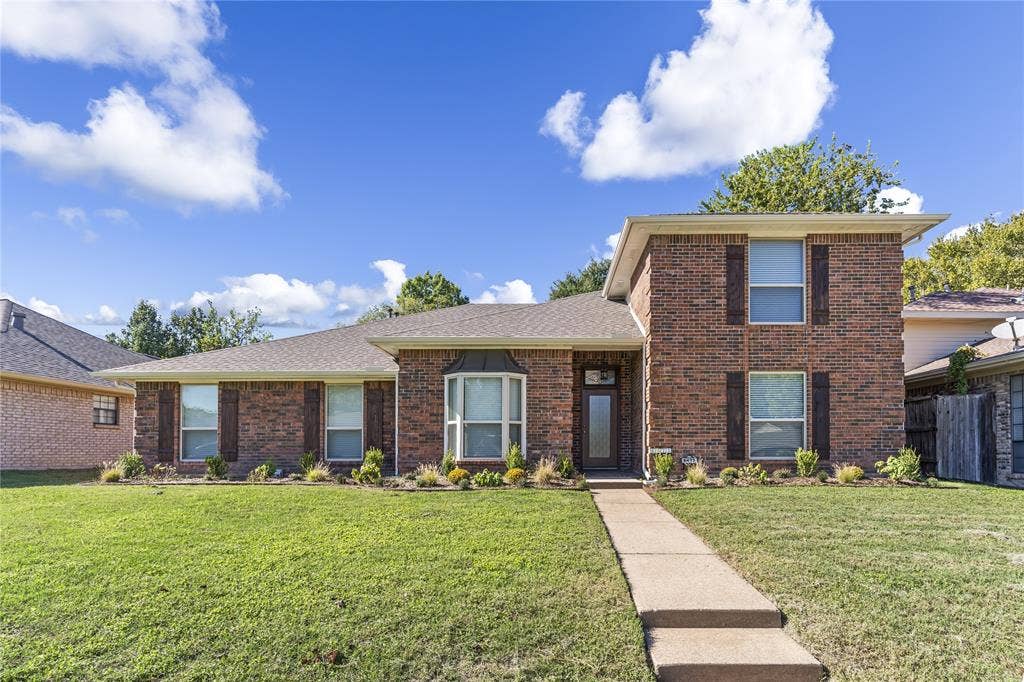 6423 Ridgemont Drive, Dallas, TX 75214 Brick exterior with brown shutters, a bay window, and a concrete walkway
