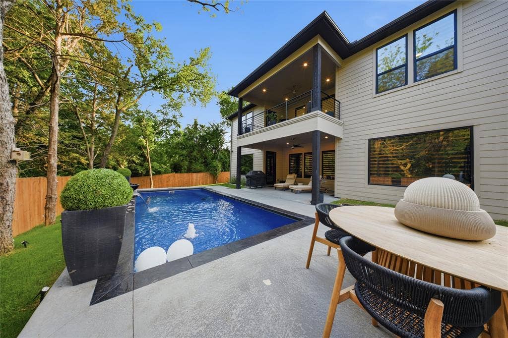 522 S Clark Road, Cedar Hill, TX 75104 Contemporary exterior with horizontal siding, an upper-level balcony, a lower-level covered patio, a rectangular swimming pool, and a concrete patio