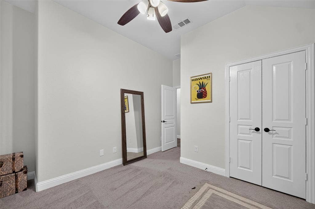 3210 Creekhaven Drive, Melissa, TX 75454 Vaulted ceilings, neutral wall tones, carpeted flooring, double-panel doors, and a ceiling fan with integrated lighting