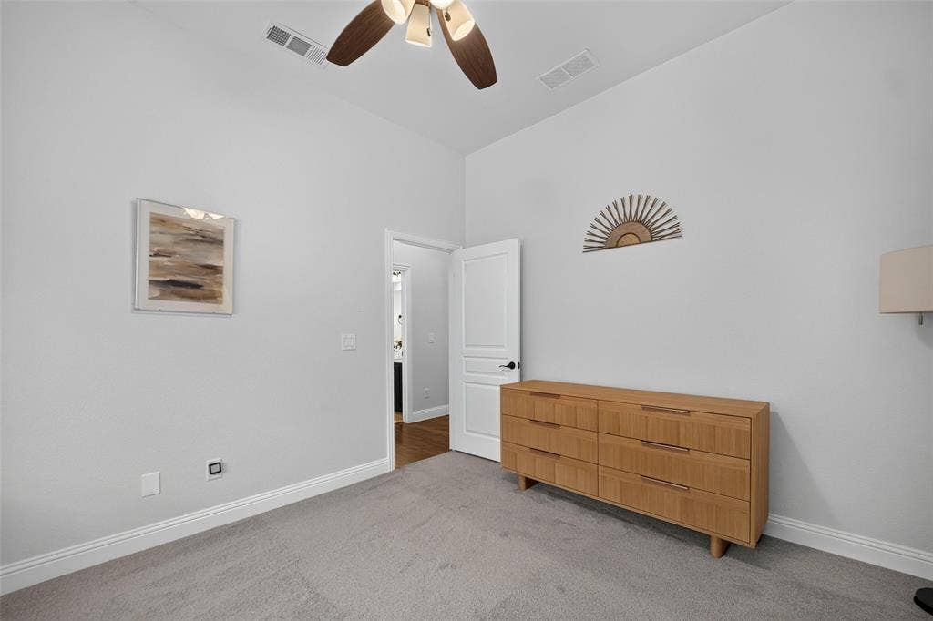 3210 Creekhaven Drive, Melissa, TX 75454 High ceiling featuring a multi-blade ceiling fan with integrated lighting and neutral carpeting