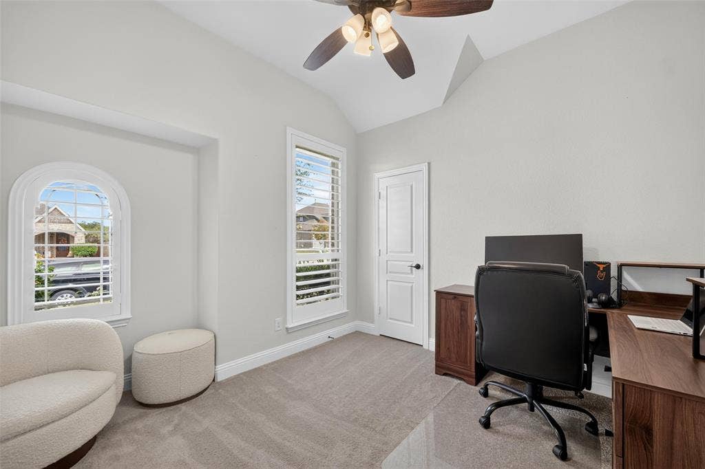 3210 Creekhaven Drive, Melissa, TX 75454 Vaulted ceilings, arched window, plantation shutters, neutral carpeting, and a ceiling fan with integrated lighting