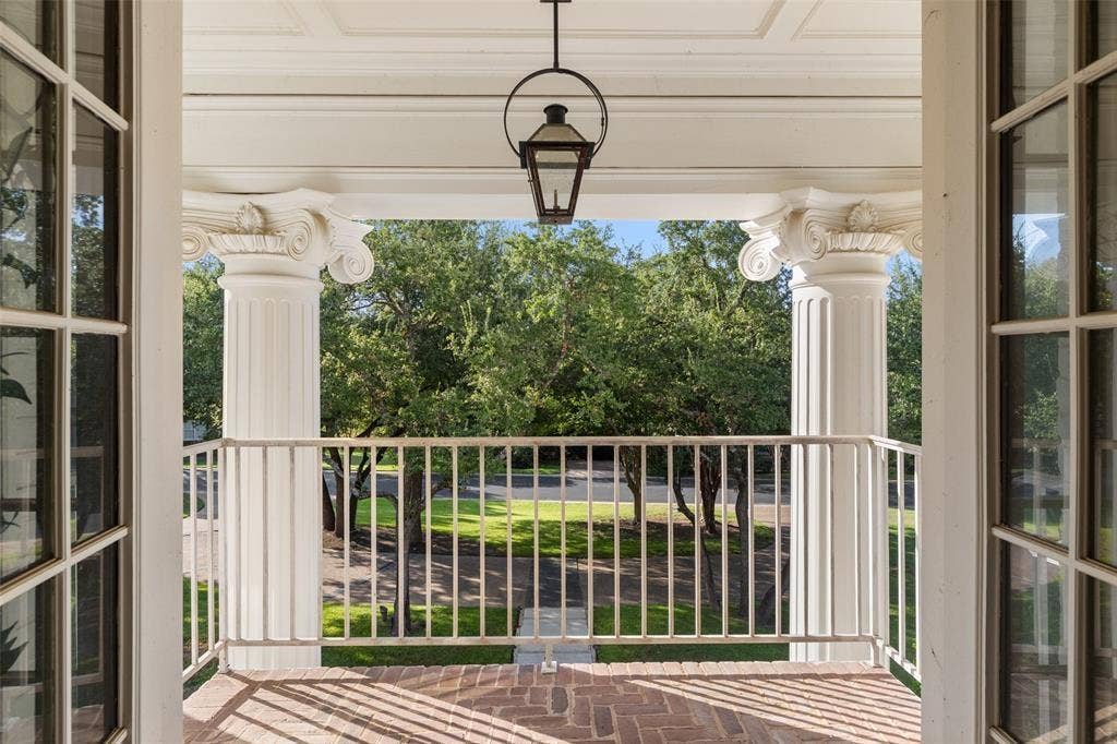 4201 Green Cliffs Road, Austin, TX 78746 Portico with brick flooring, fluted columns featuring ornate capitals, and a white balustrade