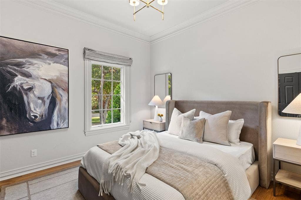 4201 Green Cliffs Road, Austin, TX 78746 Wood-finish flooring, crown molding, and a window with exterior tree scenery
