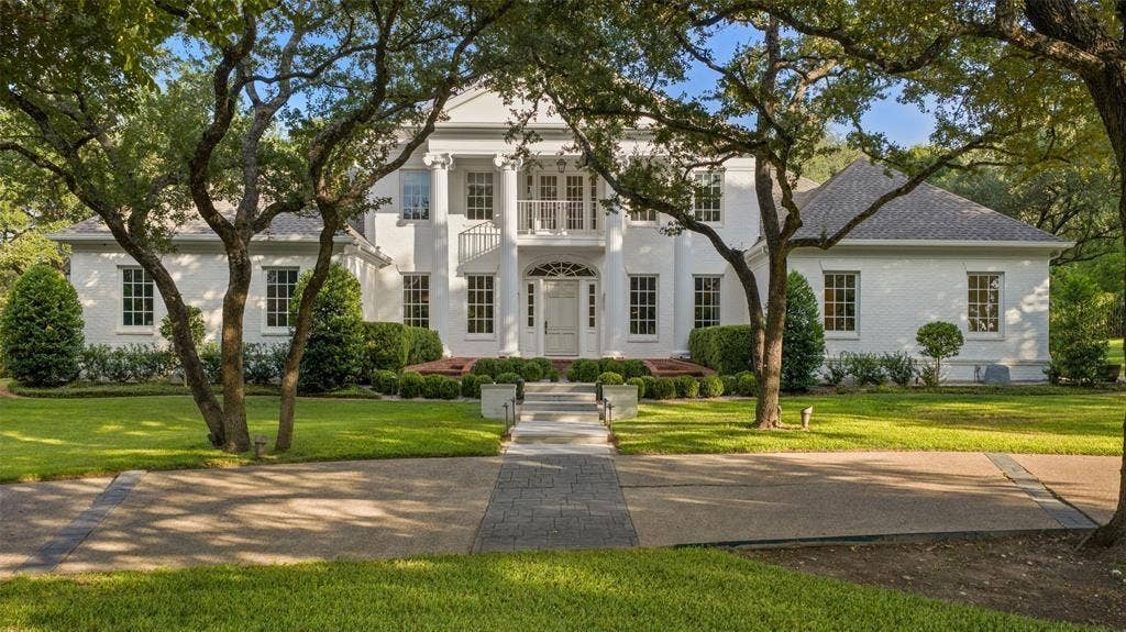 4201 Green Cliffs Road, Austin, TX 78746 White brick facade with a grand portico entry featuring columns and an upper-level balcony