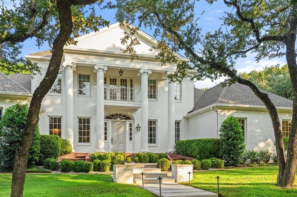4201 Green Cliffs Road, Austin, TX 78746 Grand white brick exterior with stately columns and a second-story balcony