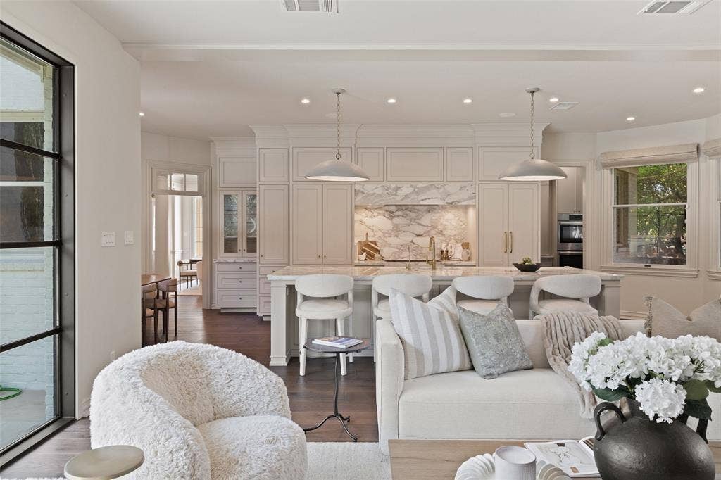 4201 Green Cliffs Road, Austin, TX 78746 Gourmet kitchen with custom cabinetry, large island with seating, integrated appliances, and a marble backsplash