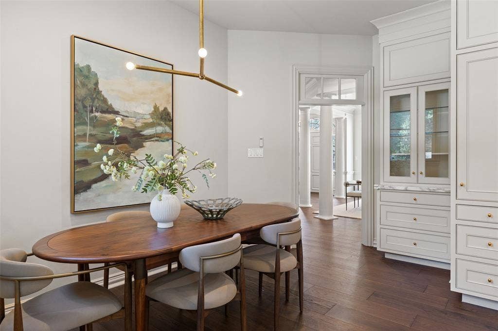 4201 Green Cliffs Road, Austin, TX 78746 Built-in cabinetry with glass-front display, dark wood-finish flooring, recessed lighting, and a modern linear chandelier
