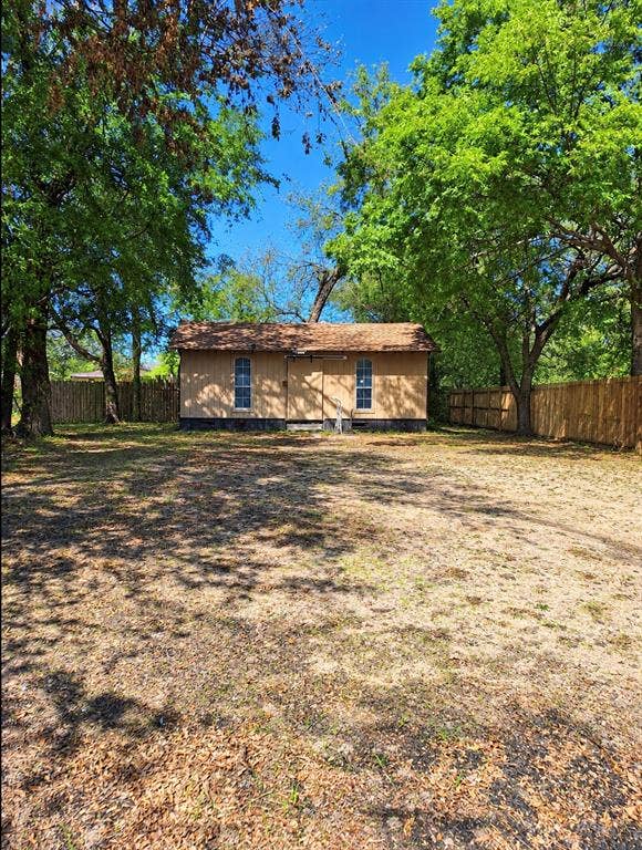 1514 Oneal Street, Greenville, TX 75401 Freestanding structure featuring two windows and a shingle roof