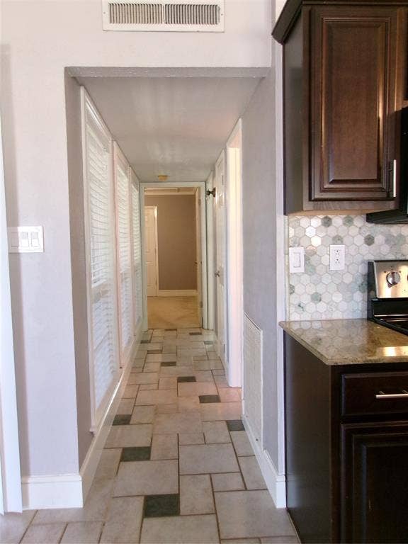 665 Stonewall Drive, Grand Prairie, TX 75052 Hallway featuring patterned tile flooring