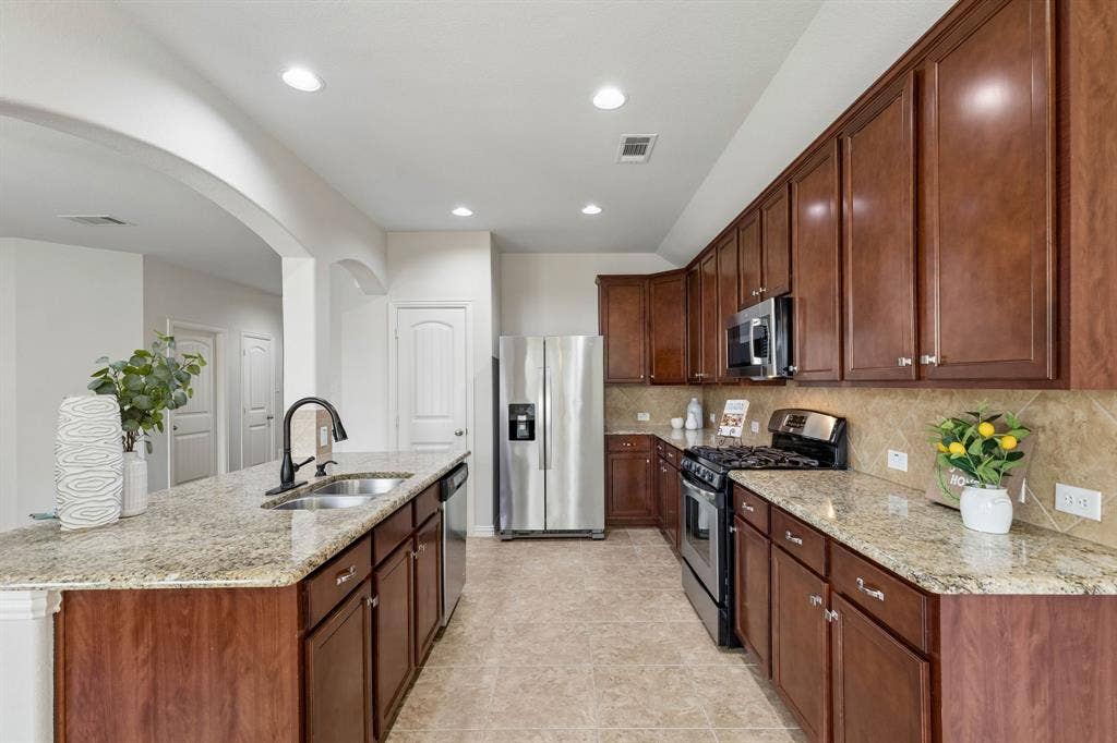 1906 Faircrest Lane, Wylie, TX 75098 The kitchen offers abundant workspace and storage! 42in upper cabinets, pantry and granite countertops make this a spectular kitchen!