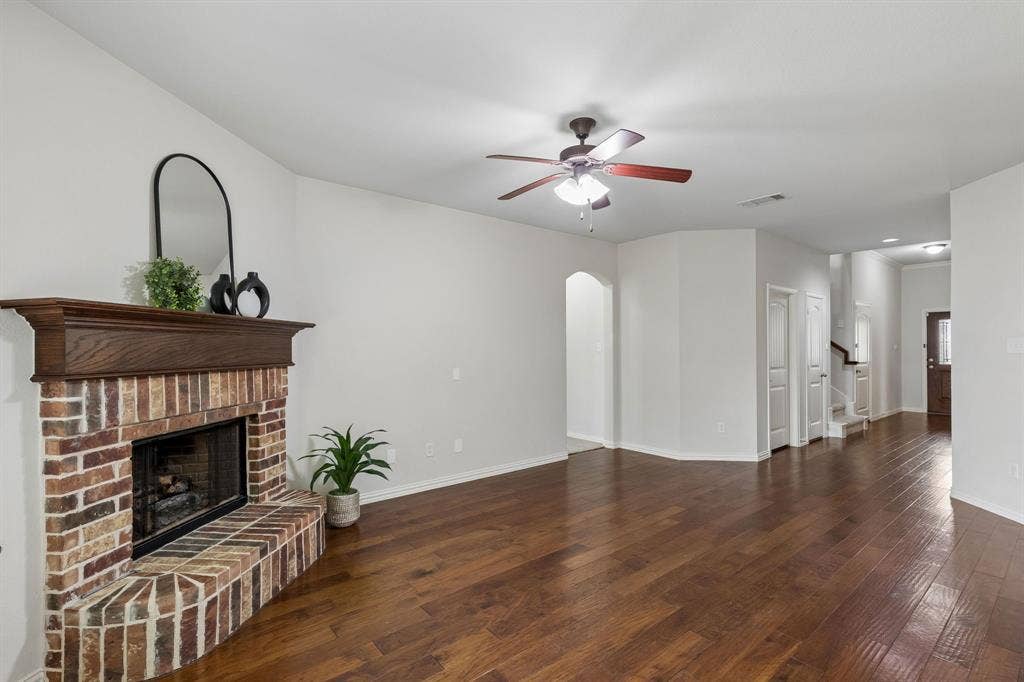 1906 Faircrest Lane, Wylie, TX 75098 The view toward the entry from the living room showcases the hardwood flooring that graces the living and entry.