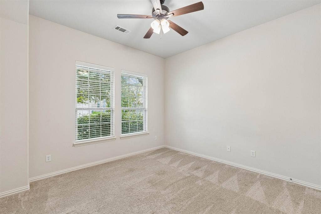 1906 Faircrest Lane, Wylie, TX 75098 Split secondary bedroom with ceiling fan and carpet.