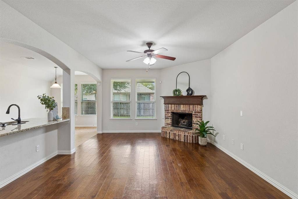 1906 Faircrest Lane, Wylie, TX 75098 The spacious and inviting living room has great flow with the dining and kitchen areas. Perfect for entertaining. Natural light gleams off the rich hardwood flooring.