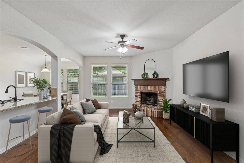 1906 Faircrest Lane, Wylie, TX 75098 The spacious and inviting living room has great flow with the dining and kitchen areas. Perfect for entertaining. Natural light gleams off the rich hardwood flooring. (Virtually Staged to show potential)