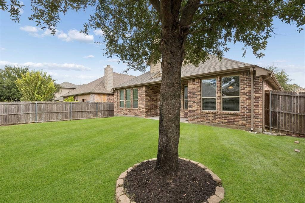 1906 Faircrest Lane, Wylie, TX 75098 This view of the backyard shows the mature tree. There is so much potential here!