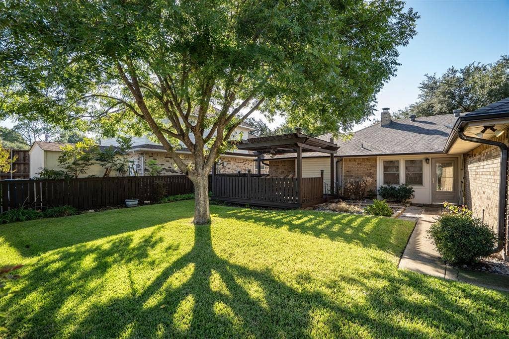 1305 Stonewood Drive, Carrollton, TX 75006 Generous, tree-shaded yard perfect for pets, play, or outdoor recreation