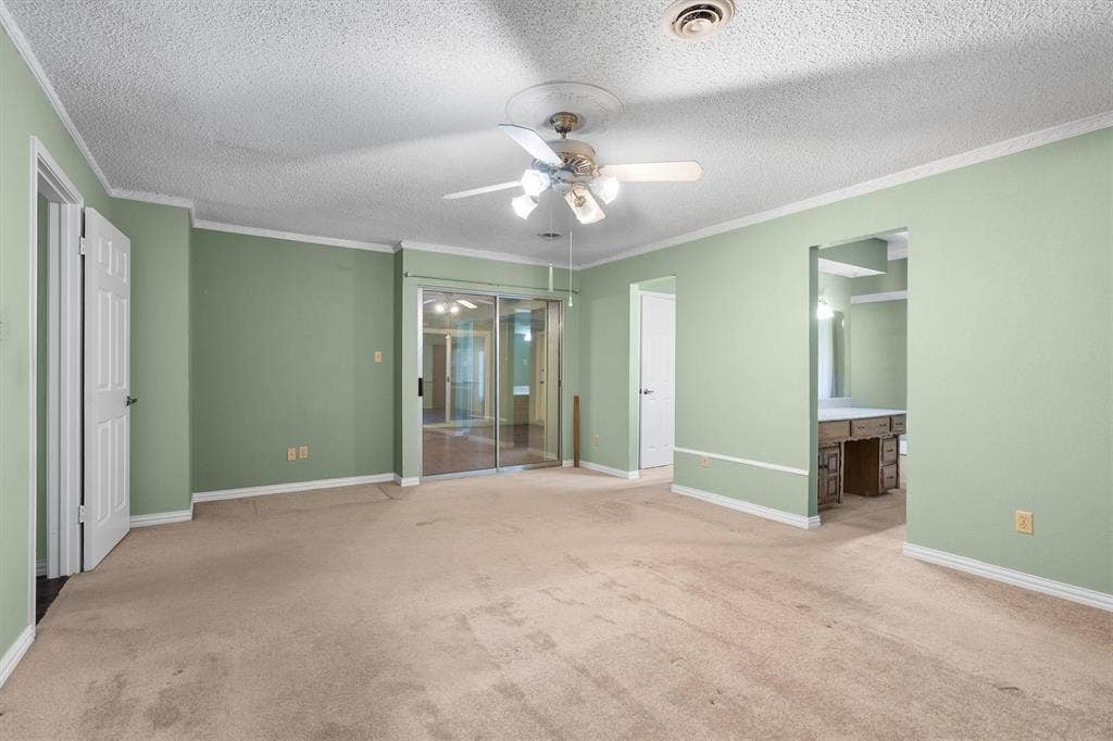 1305 Stonewood Drive, Carrollton, TX 75006 Spacious primary bedroom with ample room for a sitting area