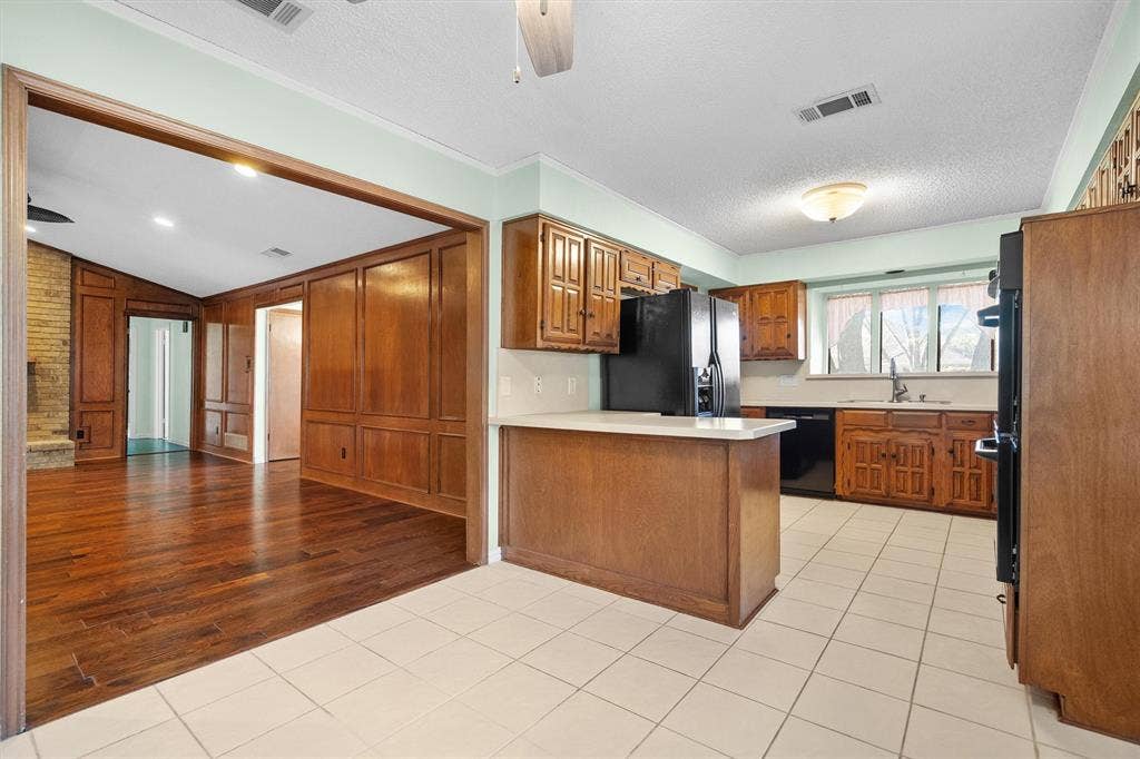 1305 Stonewood Drive, Carrollton, TX 75006 Bright kitchen featuring a charming bay window above the sink