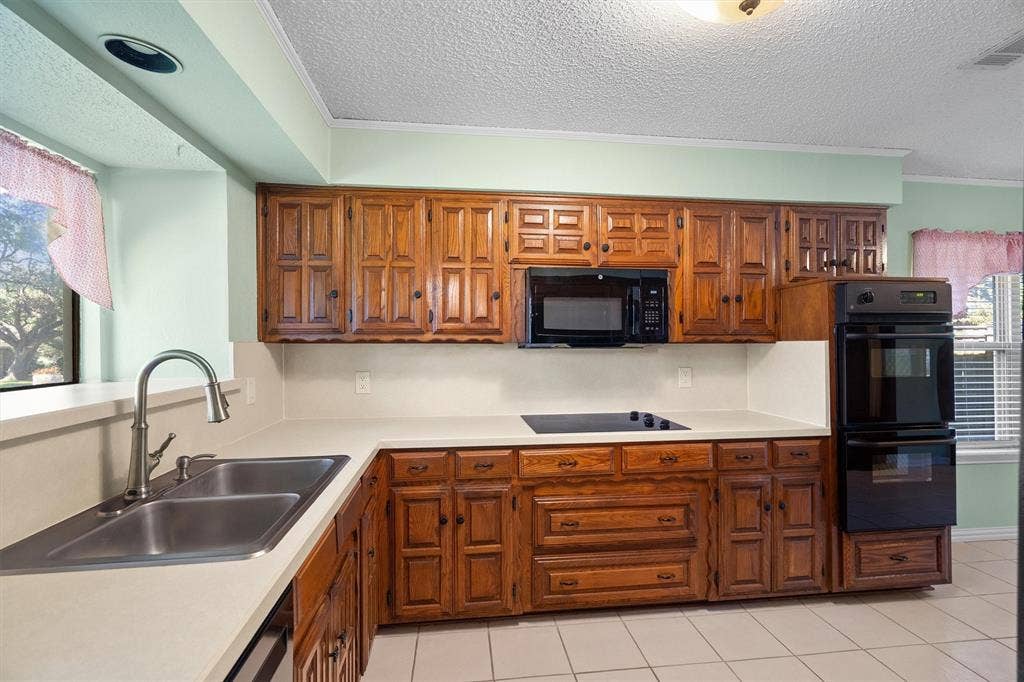 1305 Stonewood Drive, Carrollton, TX 75006 Expansive counter space perfect for party prep and easy entertaining