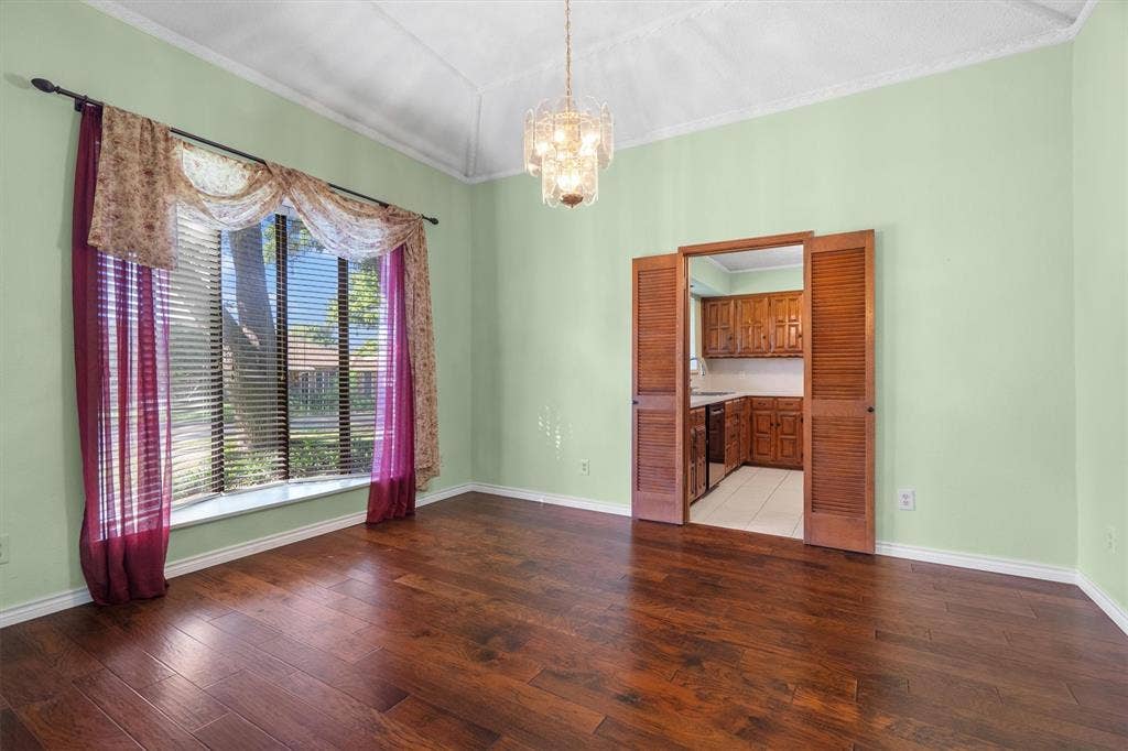 1305 Stonewood Drive, Carrollton, TX 75006 Spacious dining area adjacent to the kitchen, featuring hardwood floors and direct hall access