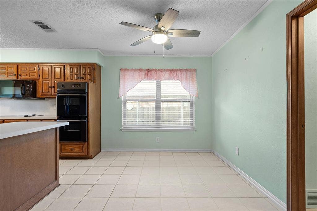 1305 Stonewood Drive, Carrollton, TX 75006 Sunlit breakfast nook adjacent to the kitchen
