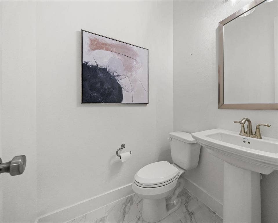 2628 Camden Court, Celina, TX 75009 Powder room featuring a pedestal sink, metallic finish faucet, ceramic tile flooring, and wall-mounted hardware