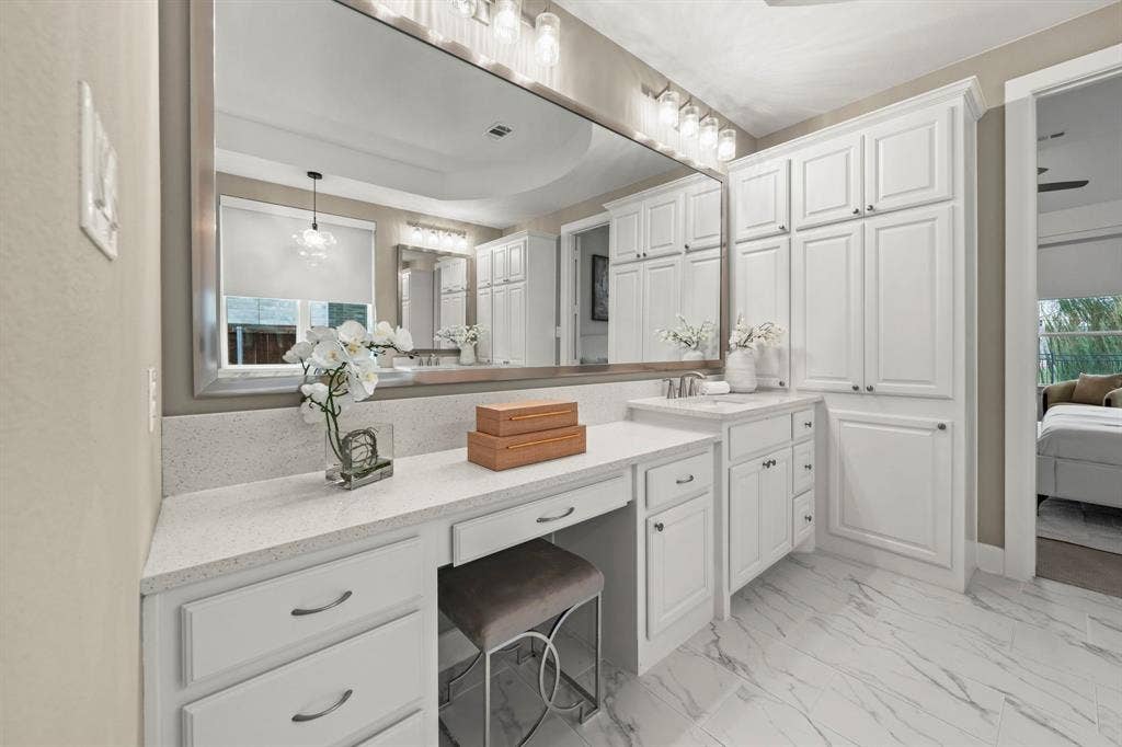 2628 Camden Court, Celina, TX 75009 Vanity featuring a full-width mirror, white cabinetry, quartz countertop, and stone-finish tile flooring