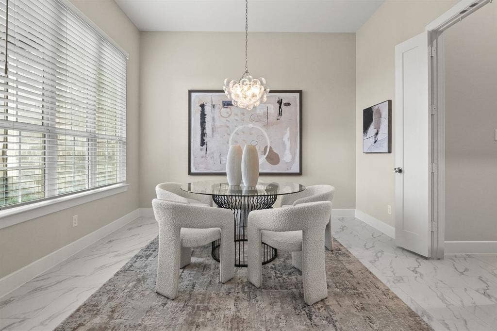 2628 Camden Court, Celina, TX 75009 Light-filled room featuring large windows, stone-finish tile flooring, and a decorative multi-bulb pendant chandelier