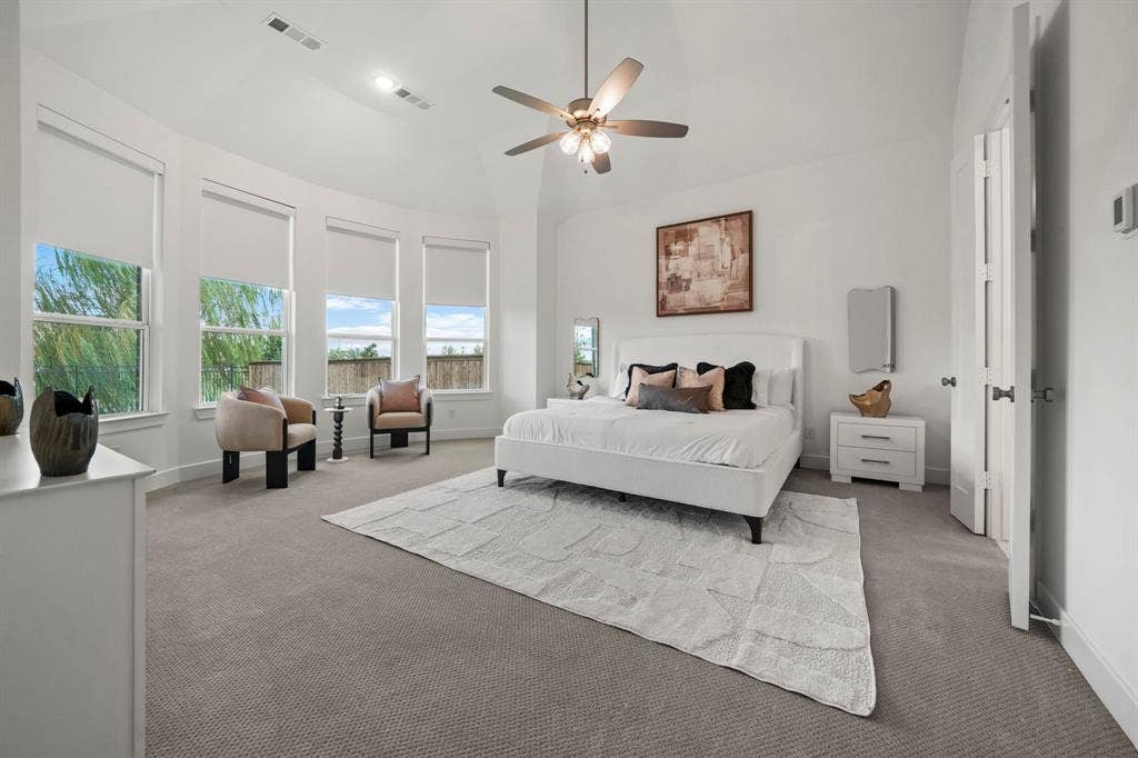 2628 Camden Court, Celina, TX 75009 Vaulted ceiling, four-paneled bay window configuration, neutral carpeting, and a multi-blade ceiling fan with integrated lighting
