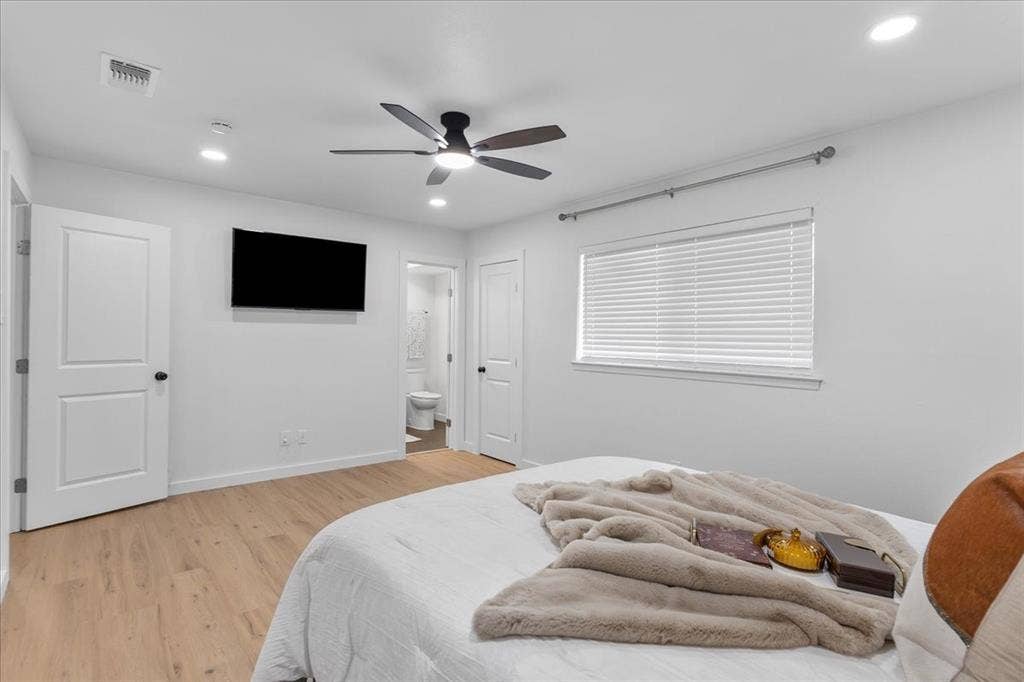 Recessed lighting, wood-finish flooring, white paneled doors, ceiling fan with light, and a window with horizontal blinds