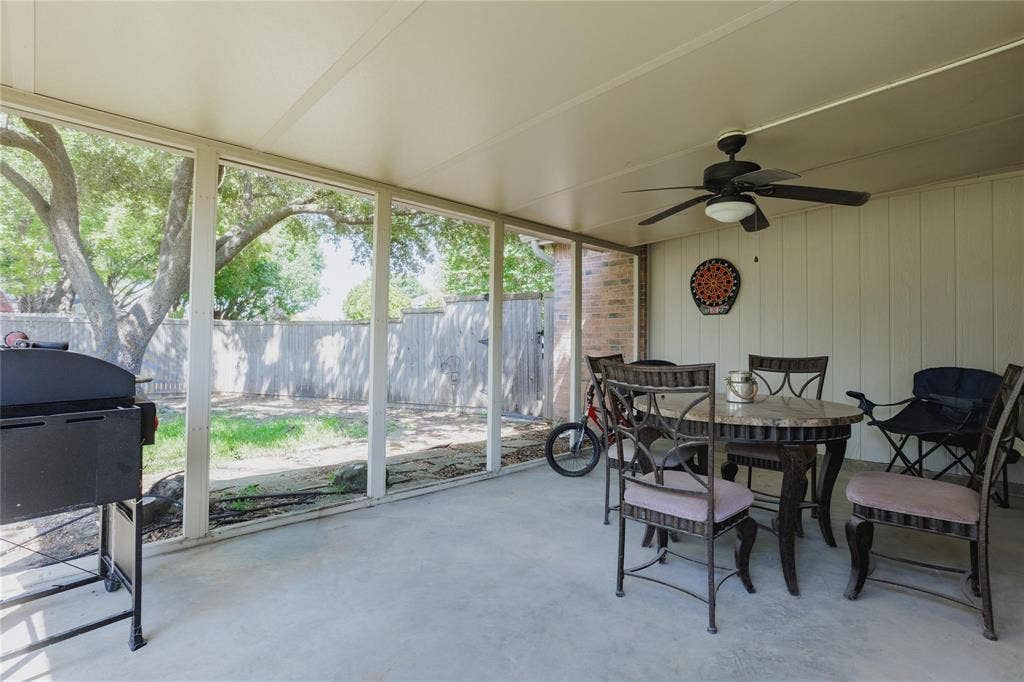2918 Periwinkle Court, Garland, TX 75040 Screened patio with a mounted ceiling fan and overhead lighting