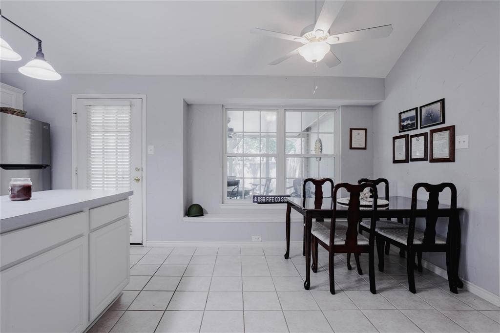2918 Periwinkle Court, Garland, TX 75040 Tile flooring, recessed window, ceiling fan with light fixture, white perimeter cabinetry, stainless steel refrigerator