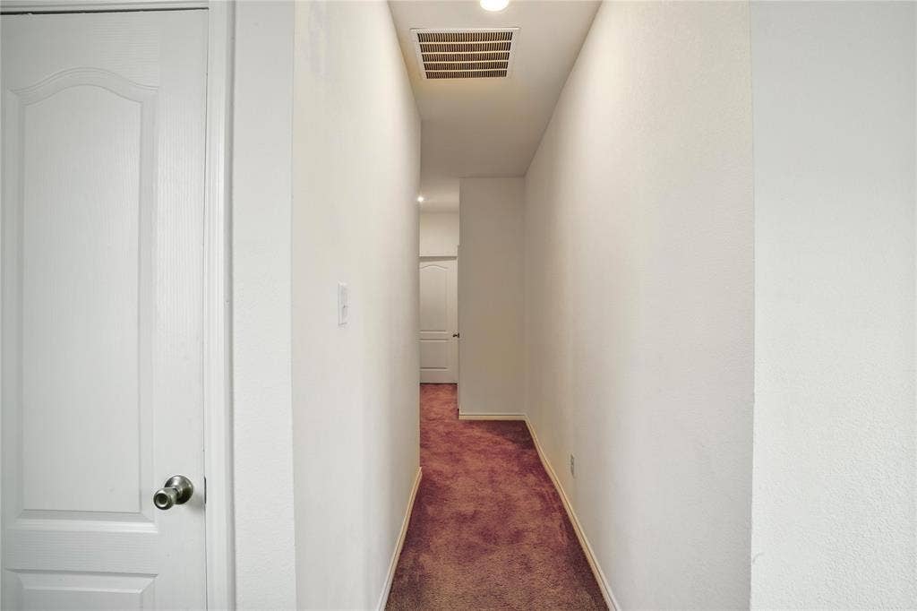 Hallway with carpet floors and recessed lighting