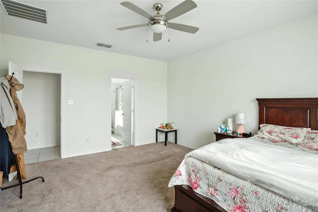 Carpeted bedroom with baseboards and ceiling fan