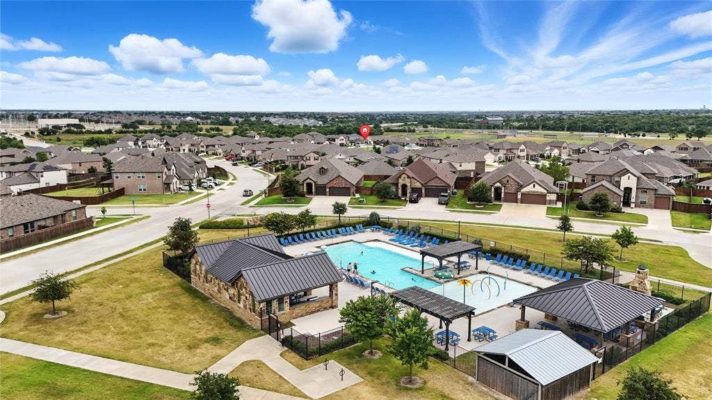 Aerial view of residential area featuring a pool area