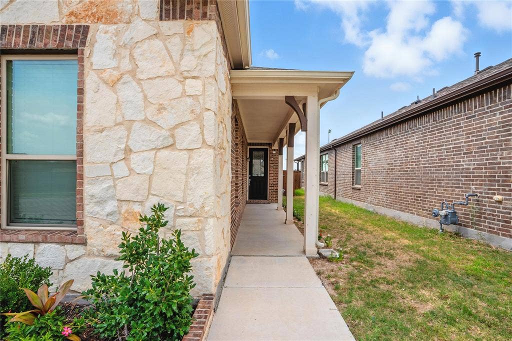 View of exterior entry with stone siding
